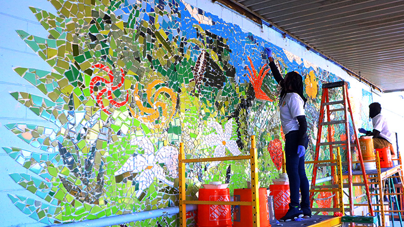 Kids building a mural