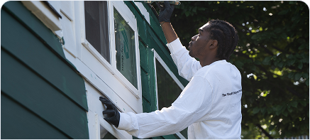 Kid painting a house